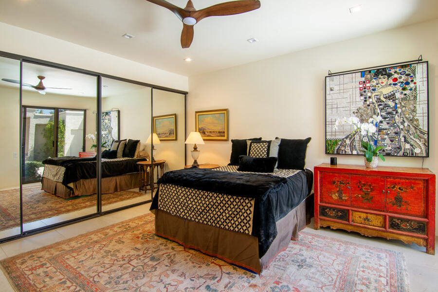 723 Inverness Drive Rancho Mirage, CA 92270 - Photo 19 of 49 a bedroom with a bed and wooden floor