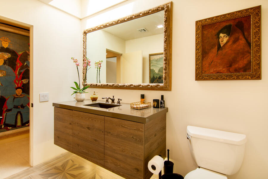723 Inverness Drive Rancho Mirage, CA 92270 - Photo 20 of 49 a bathroom with a toilet a sink and mirror
