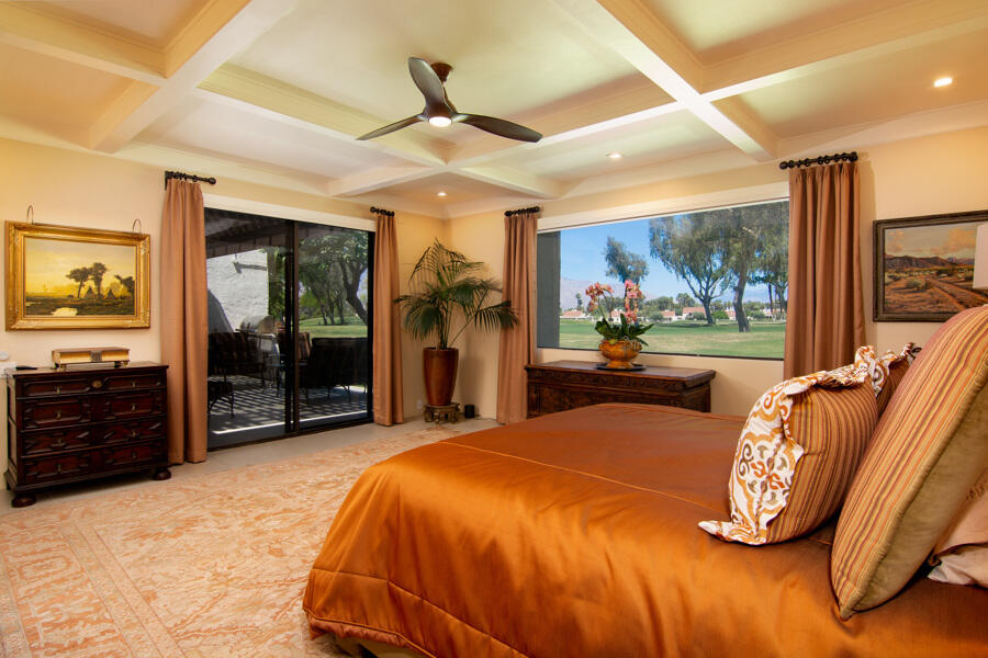 723 Inverness Drive Rancho Mirage, CA 92270 - Photo 21 of 49 a bedroom with a bed and a large mirror with a flat tv screen