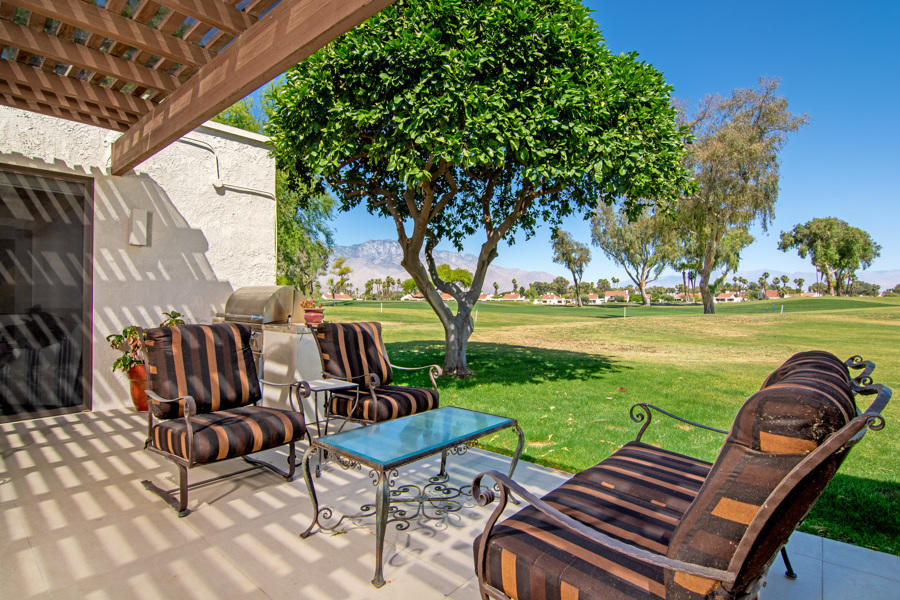 723 Inverness Drive Rancho Mirage, CA 92270 - Photo 25 of 49 a view of a patio with a table chairs and a fire pit