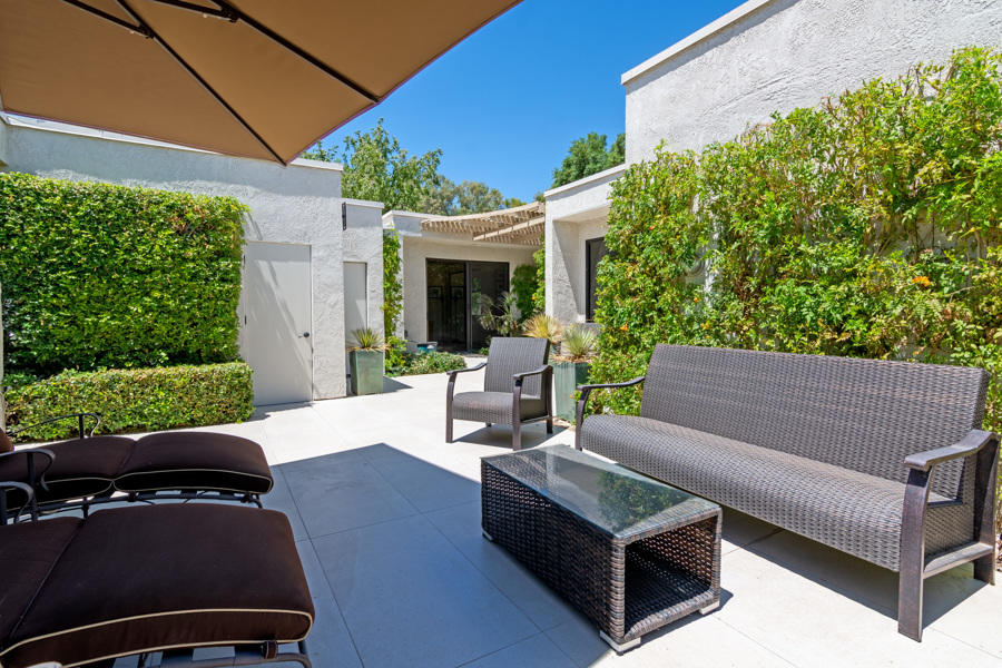 723 Inverness Drive Rancho Mirage, CA 92270 - Photo 34 of 49 a view of a patio with couches table and chairs and potted plants