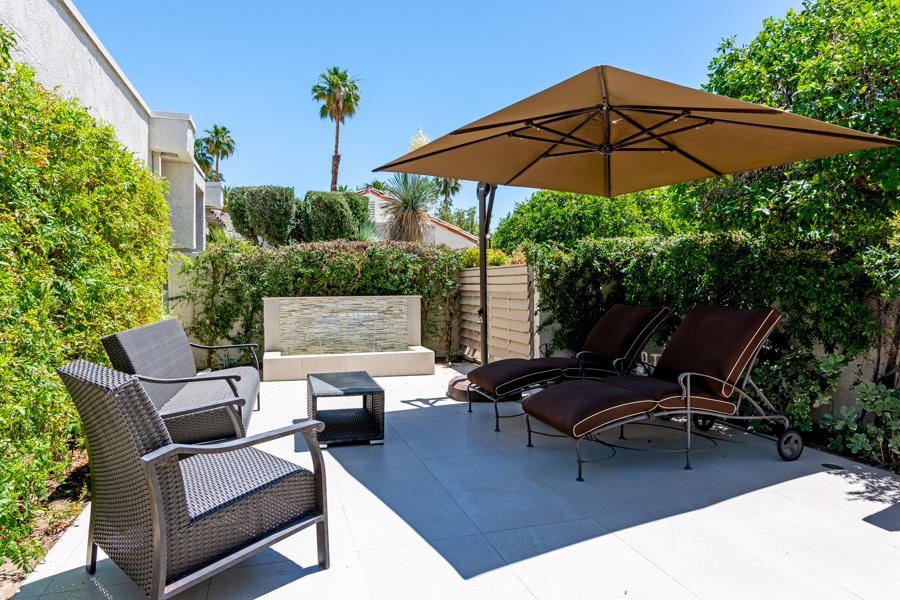 723 Inverness Drive Rancho Mirage, CA 92270 - Photo 41 of 49 a view of a backyard with furniture and a umbrella