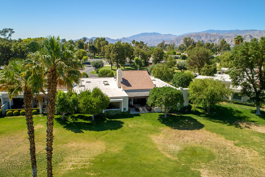 723 Inverness Drive Rancho Mirage, CA 92270 - Photo 46 of 49 a view of a garden with a building in the background