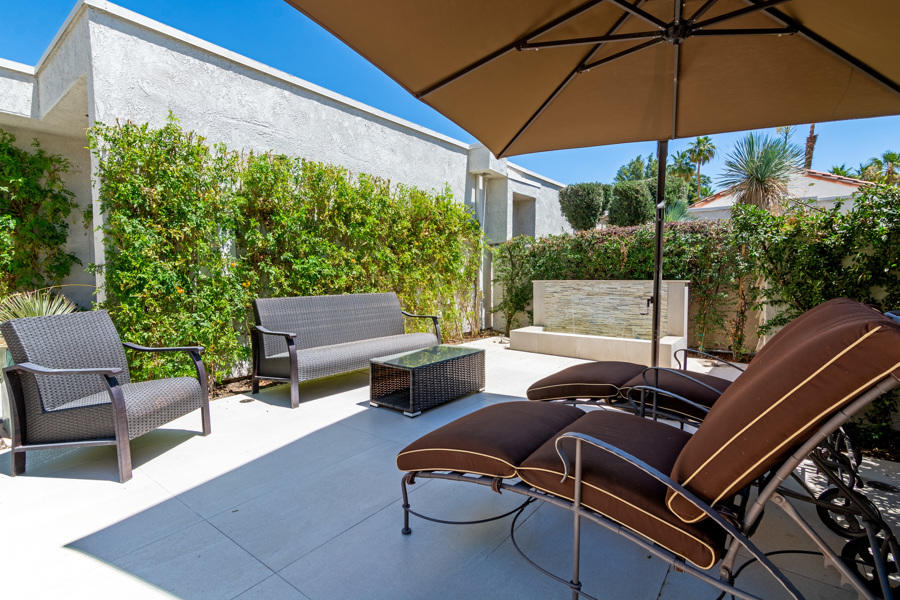 723 Inverness Drive Rancho Mirage, CA 92270 - Photo 6 of 49 a backyard of a house with table and chairs under an umbrella