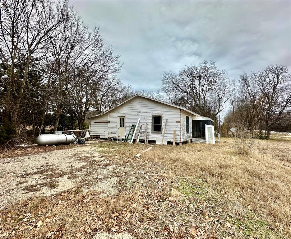 6049 Farm Road 3236 Dike, TX 75437 - Photo 2 of 12 a big house with a large tree in front of it