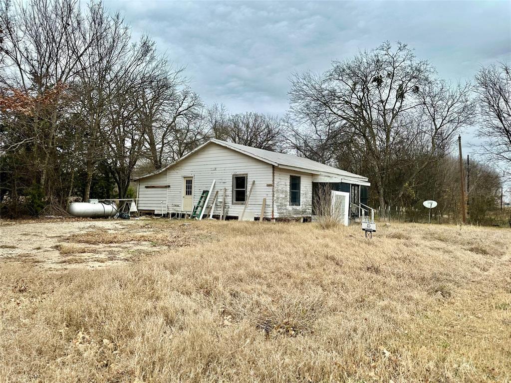 6049 Farm Road 3236 Dike, TX 75437 - Photo 3 of 12 a view of a house with a yard covered in snow