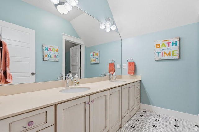 672 Perry Hollow Drive Mapleton, UT 84664 - Photo 66 of 106 Bathroom featuring a dual vanity with light-toned countertops, white cabinetry with decorative knobs, and undermount sinks