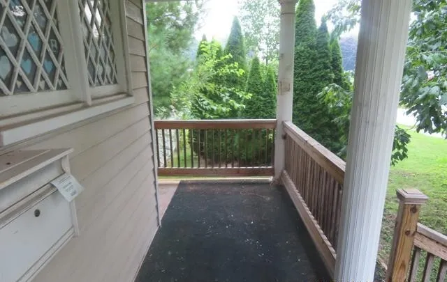 a view of a balcony with wooden floor