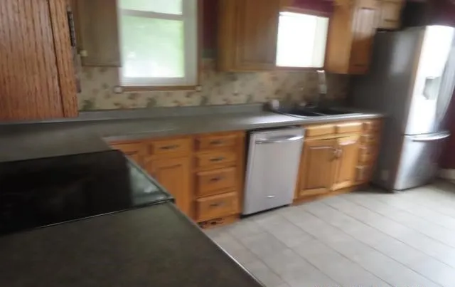 a kitchen with granite countertop white cabinets and white appliances