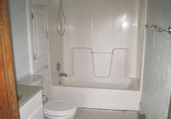 a bathroom with a tub and a shower