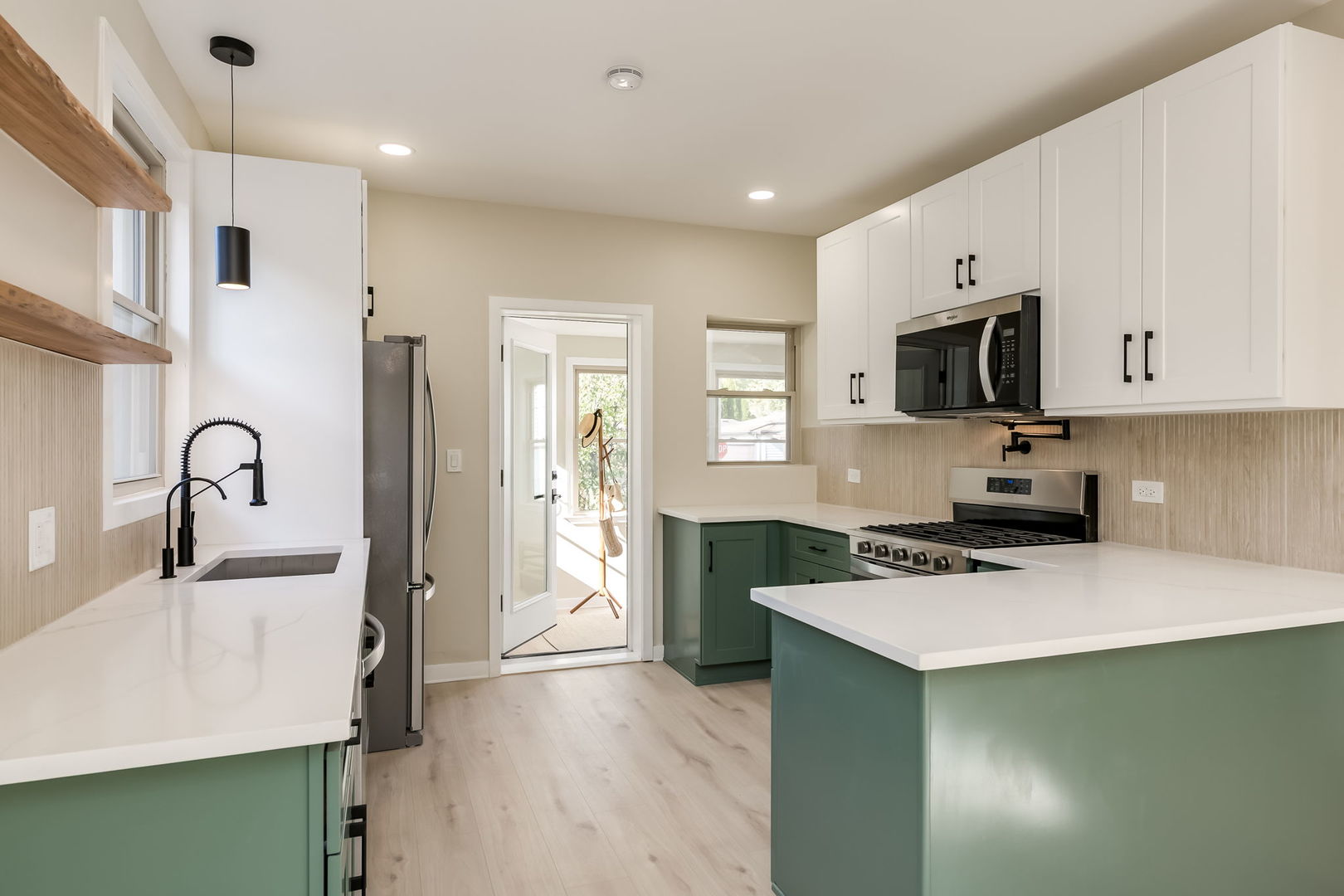 5144 North Kolmar Avenue Chicago, IL 60630 - Photo 7 of 27 a kitchen with stainless steel appliances a stove a sink a microwave a refrigerator a counter top space and cabinets