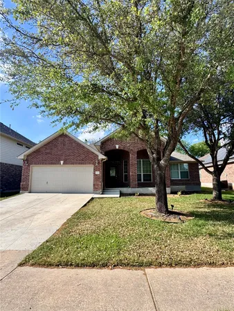 a house that has a tree in front of it