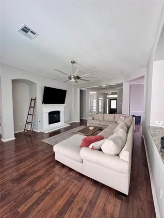 a living room with furniture and a wooden floor