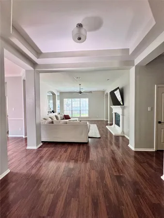 a view of a living room and kitchen with hardwood floor