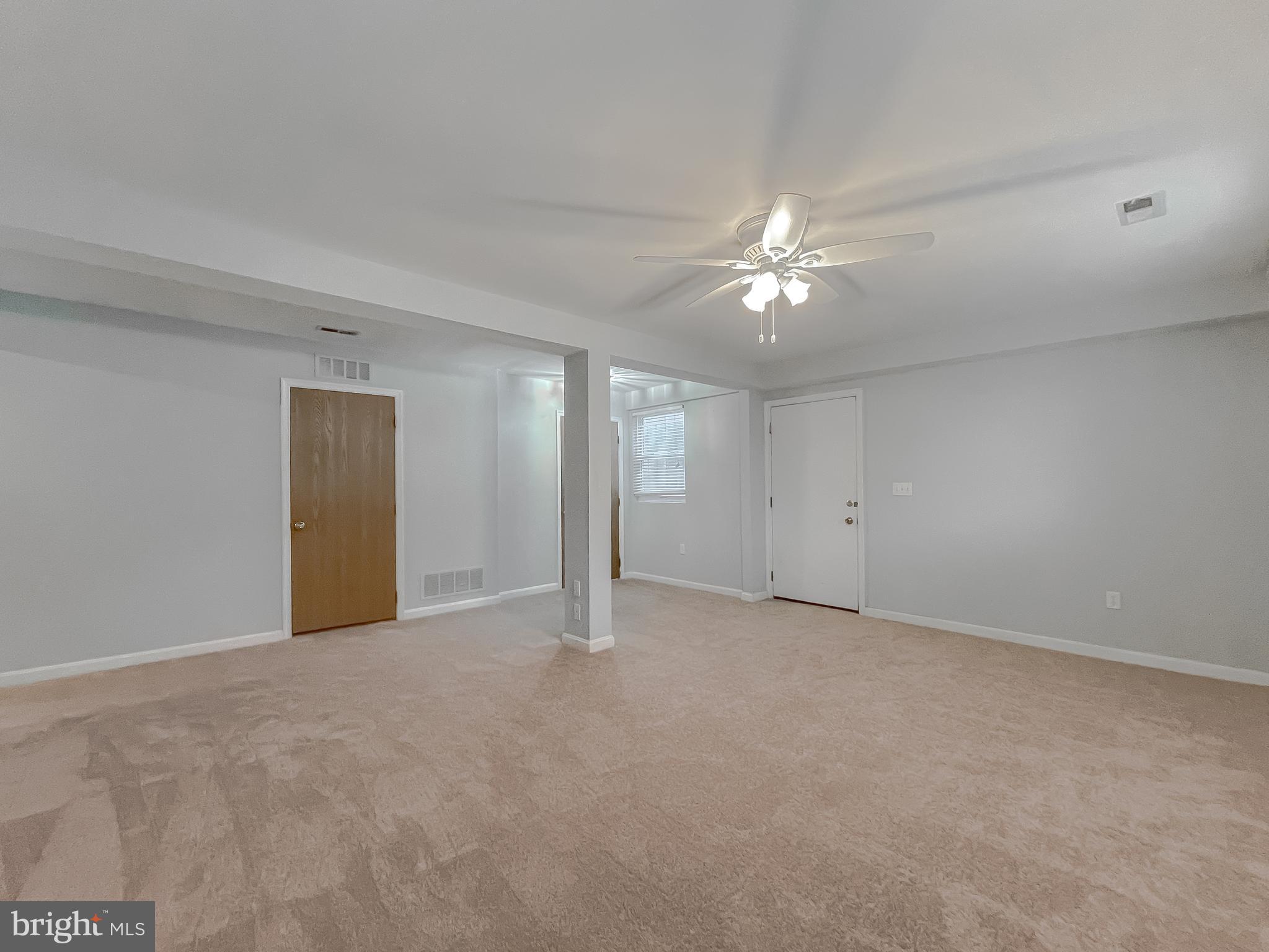 4485 Solomons Island Road Huntingtown, MD 20639 - Photo 35 of 46 a view of an empty room with a ceiling fan