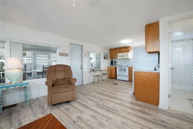 a living room with furniture and a kitchen view