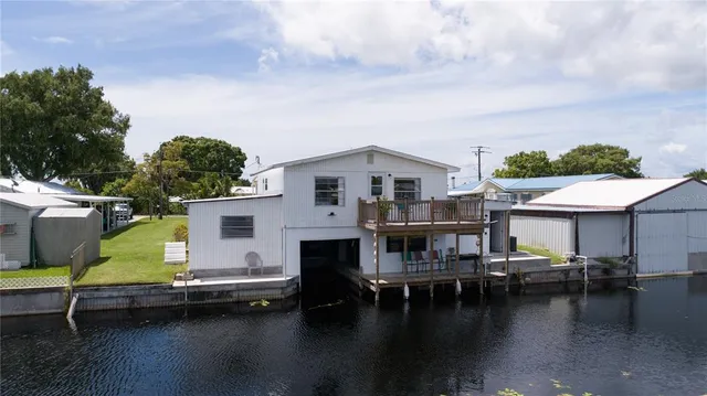 a view of swimming pool with outdoor seating and a lots of trees in the background