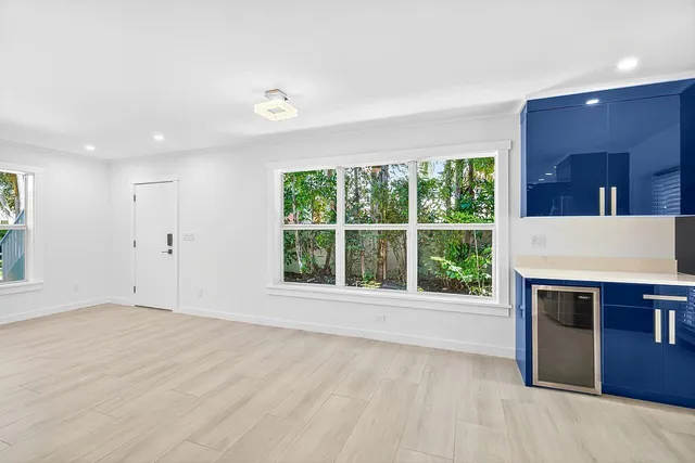 a view of an empty room with a fireplace and a window