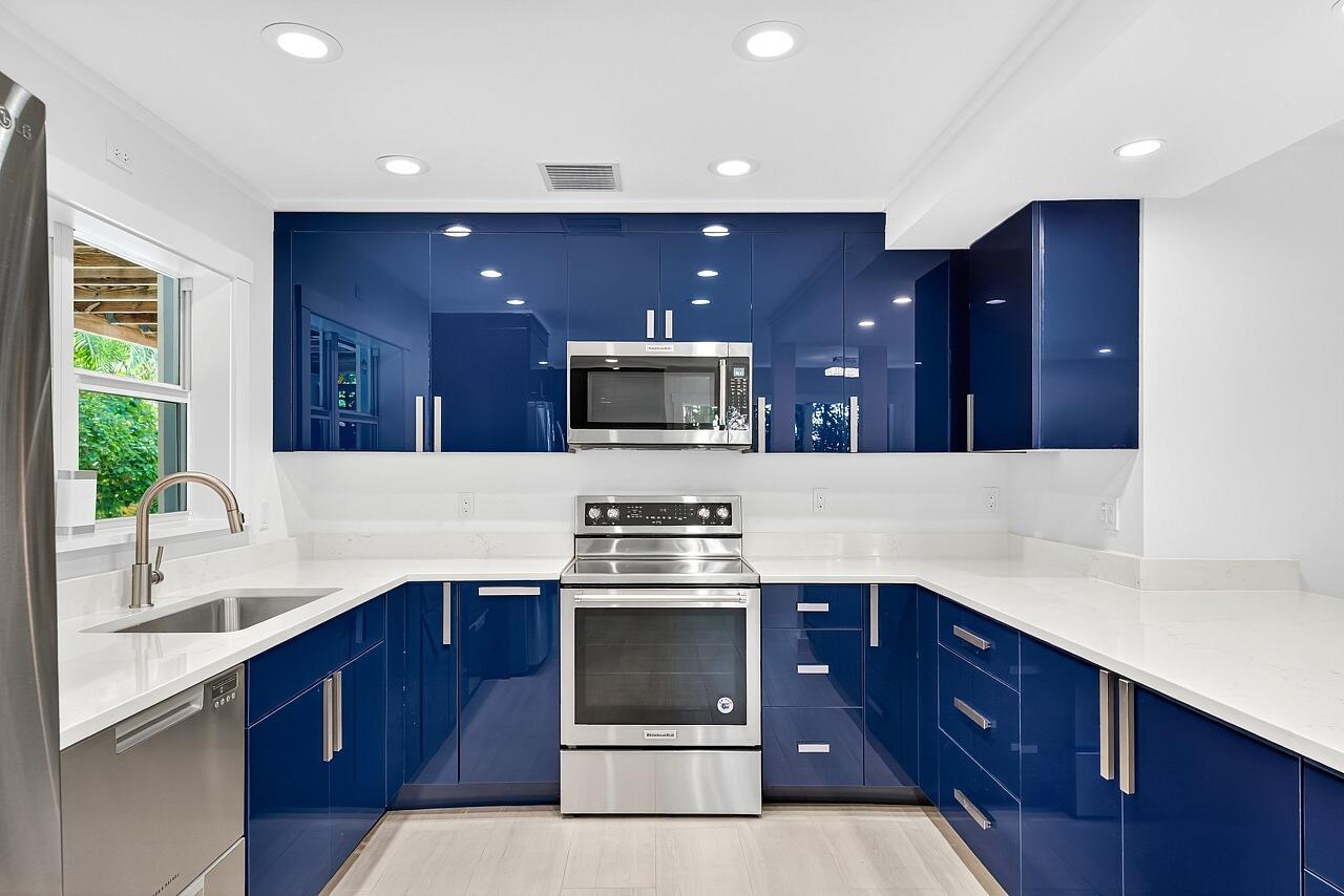 924 Coquina Lane, Unit 3 Vero Beach, FL 32963 - Photo 12 of 44 a kitchen with a stove and a sink
