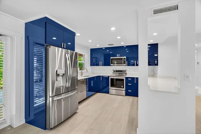 a kitchen with stainless steel appliances a refrigerator and a stove top oven