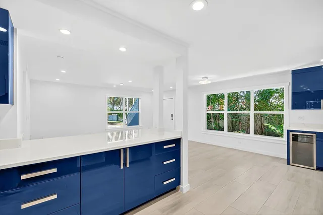a view of an empty room with a fireplace and a window