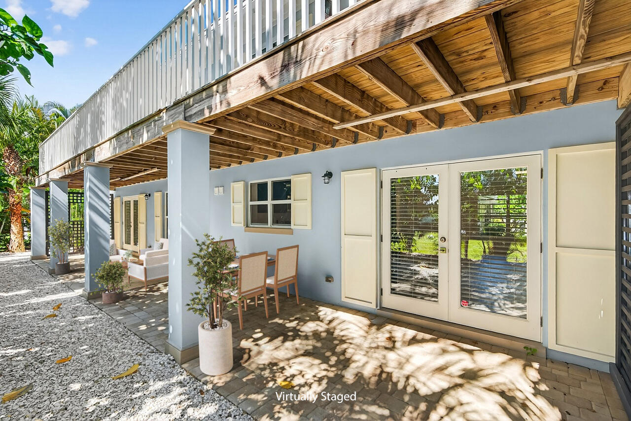 924 Coquina Lane, Unit 3 Vero Beach, FL 32963 - Photo 18 of 44 a view of a patio with table and chairs and potted plants