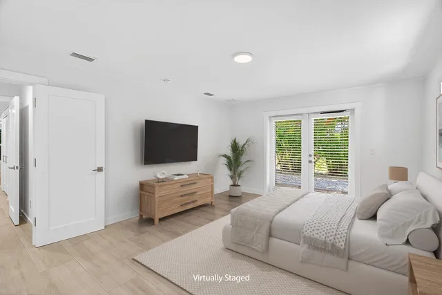 a bedroom with a bed and a flat screen television