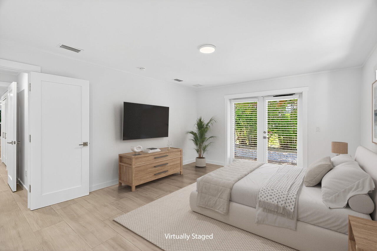 924 Coquina Lane, Unit 3 Vero Beach, FL 32963 - Photo 22 of 44 a bedroom with a bed and a flat screen television