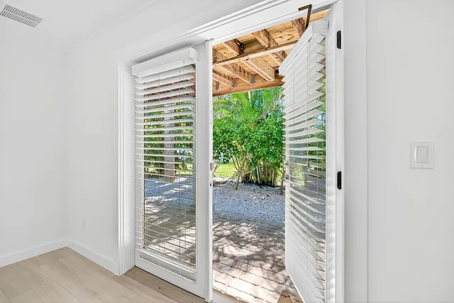 a view of a room with a large window with wooden floor