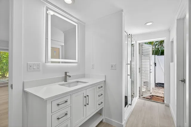 a bathroom with a sink a vanity and a mirror