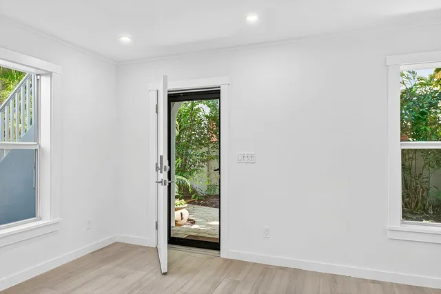 an empty room with windows and closet