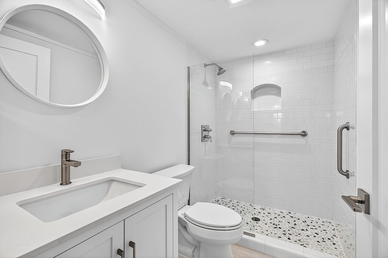 924 Coquina Lane, Unit 3 Vero Beach, FL 32963 - Photo 36 of 44 a bathroom with a sink a toilet and shower