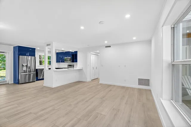 a view of a kitchen with a sink cabinets and wooden floor