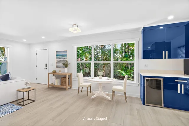 a living room with furniture a fireplace and a table