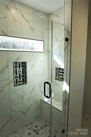 a white toilet sitting next to a white wall