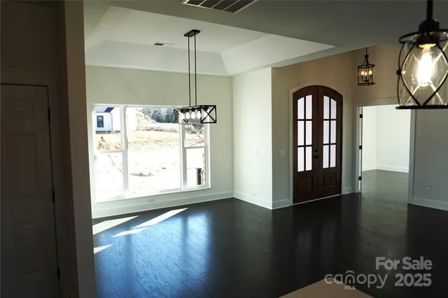 a view of an entryway with wooden floor