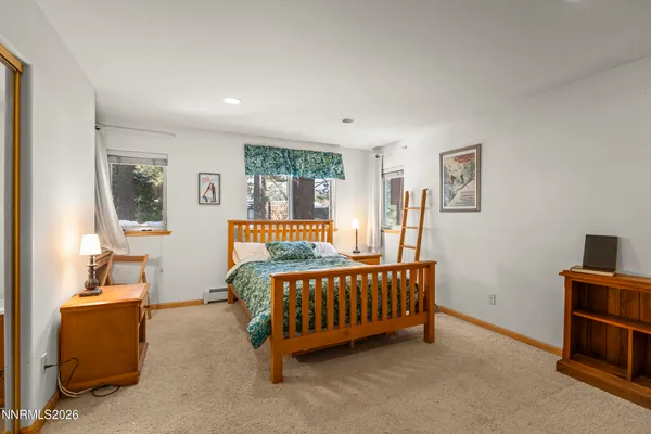 a bedroom with furniture and a window