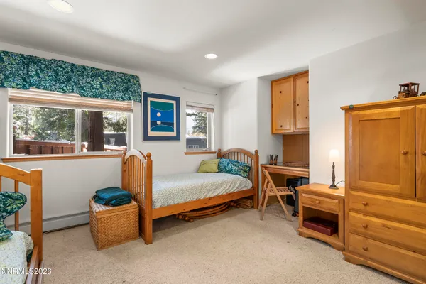 a bedroom with furniture and a window