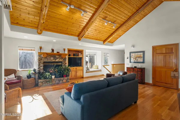 a living room with furniture a fireplace and a flat screen tv