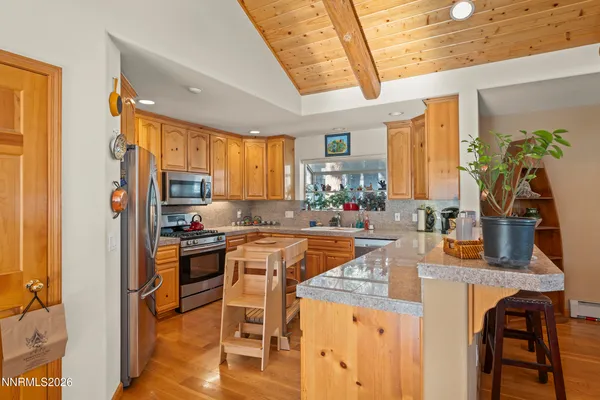 a kitchen with stainless steel appliances granite countertop sink stove and refrigerator