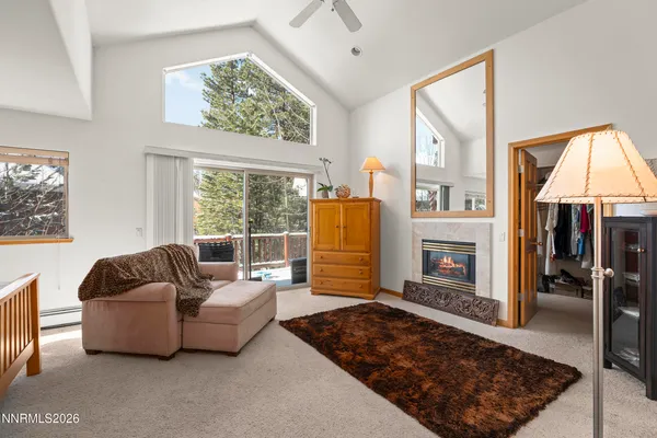 a living room with fireplace furniture and a window