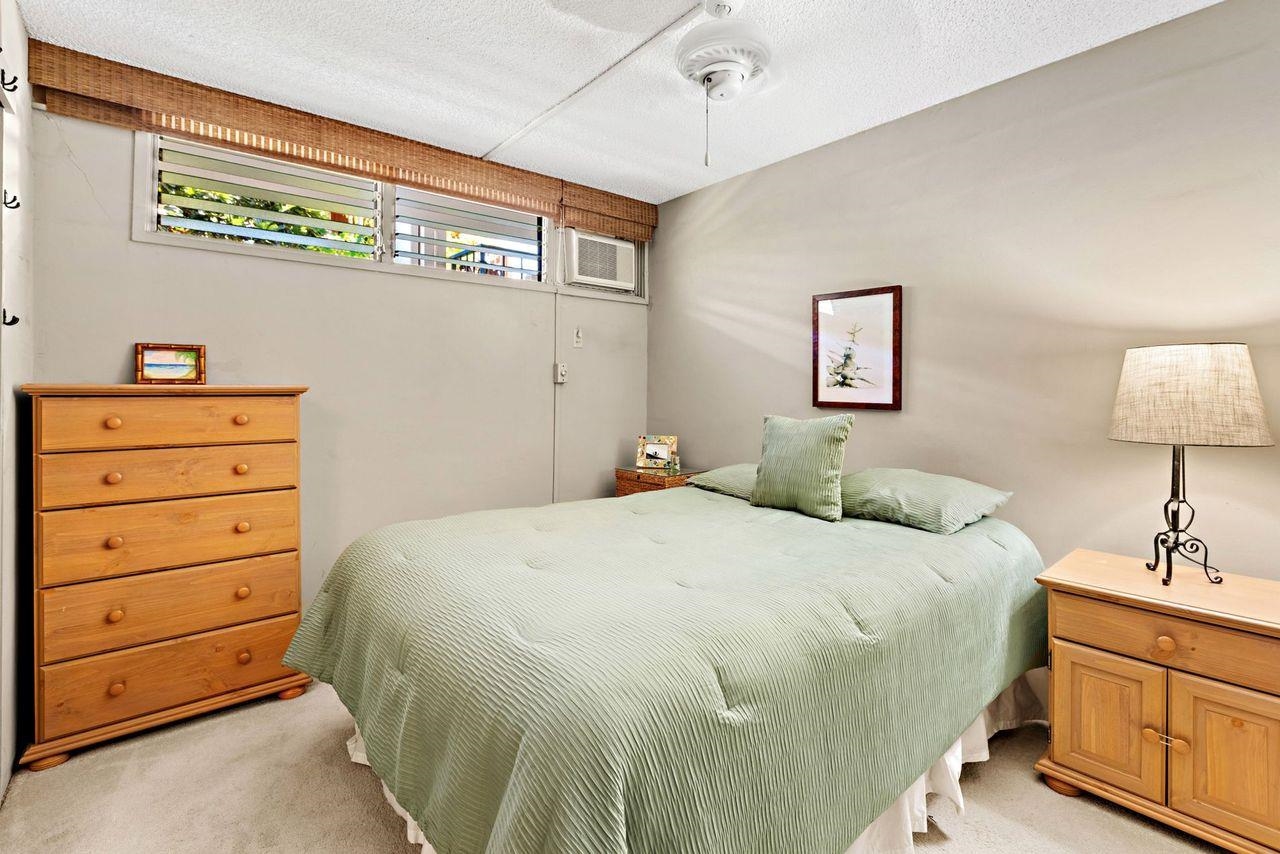 3750 Lower Honoapiilani Road, Unit 202 Lahaina, HI 96761 - Photo 12 of 22 a bedroom with a bed and a dresser