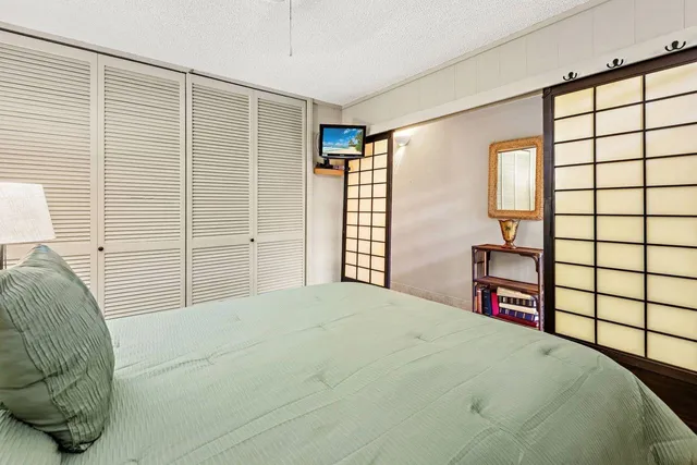 a bedroom with a bed and a large window