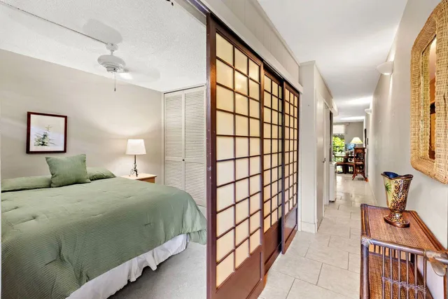 a bedroom with a bed and a large window