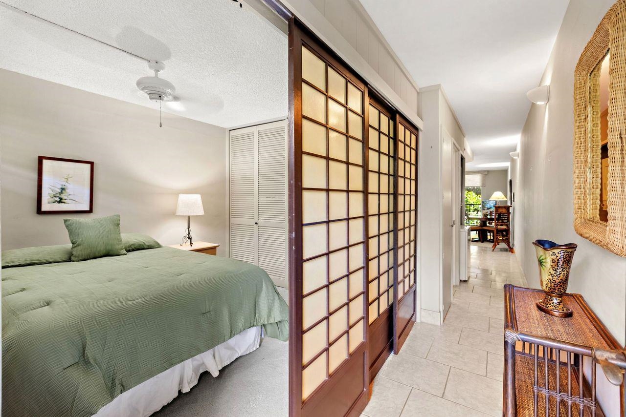 3750 Lower Honoapiilani Road, Unit 202 Lahaina, HI 96761 - Photo 14 of 22 a bedroom with a bed and a large window