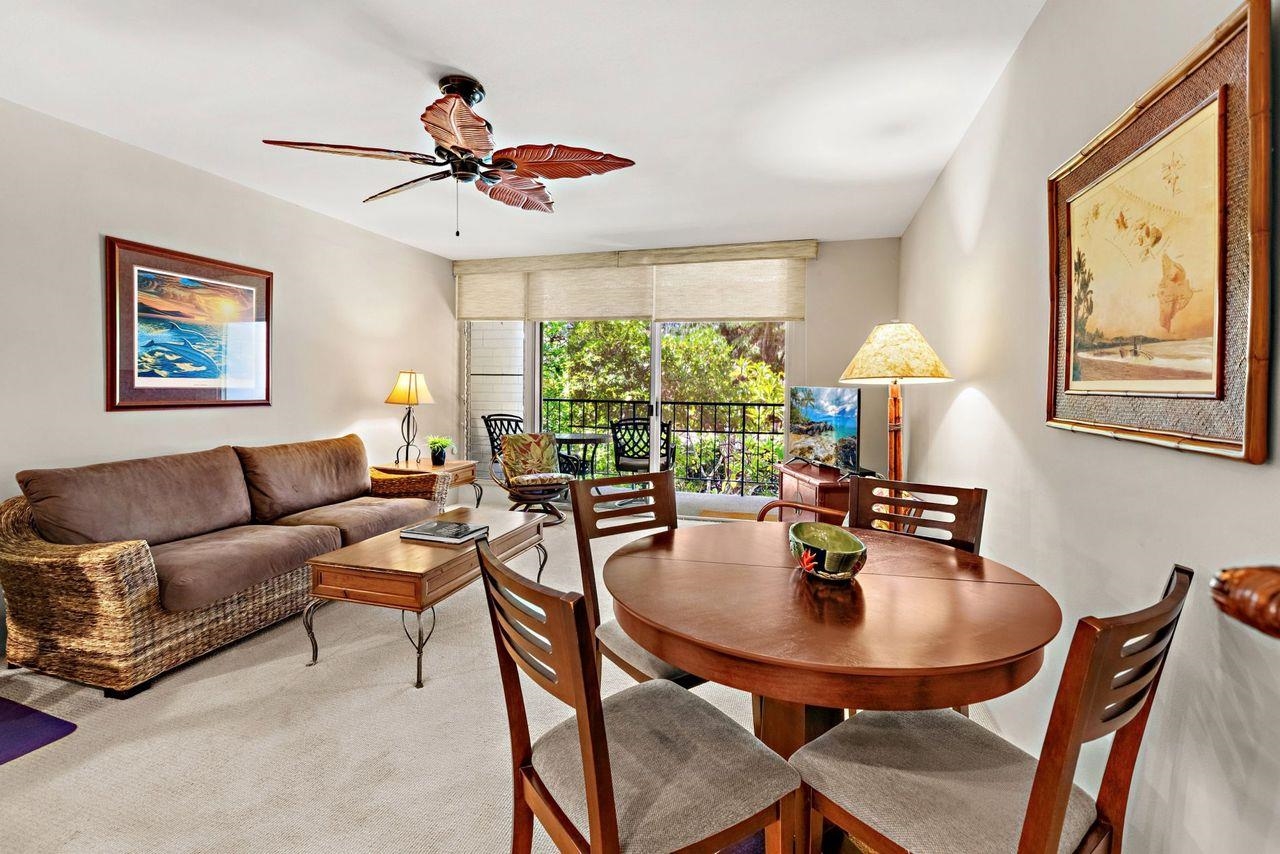 3750 Lower Honoapiilani Road, Unit 202 Lahaina, HI 96761 - Photo 5 of 22 a dining room with furniture a large window and a chandelier