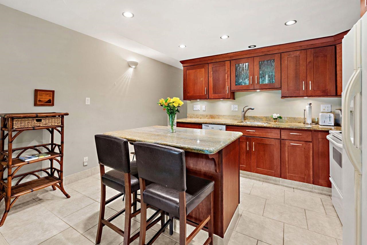 3750 Lower Honoapiilani Road, Unit 202 Lahaina, HI 96761 - Photo 6 of 22 a kitchen with stainless steel appliances granite countertop a sink and a refrigerator