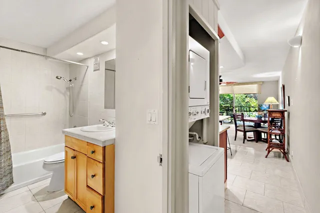 a spacious bathroom with a granite countertop sink a mirror and a shower