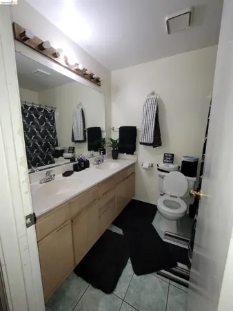 a bathroom with a sink a toilet and mirror