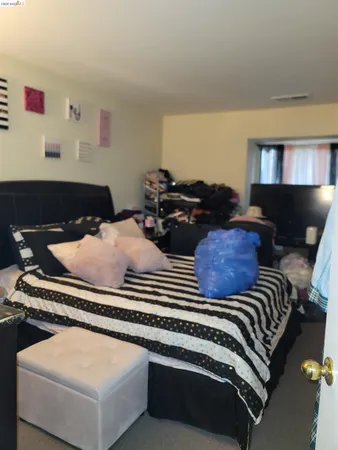 a bed room with two beds and a lamp